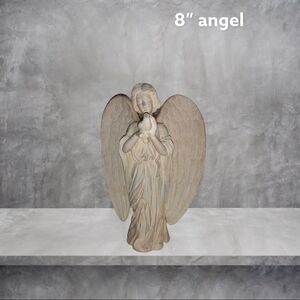 8” cream colored angel holding a dove !